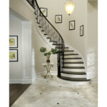 curved staircase with hammered spoon metal balusters