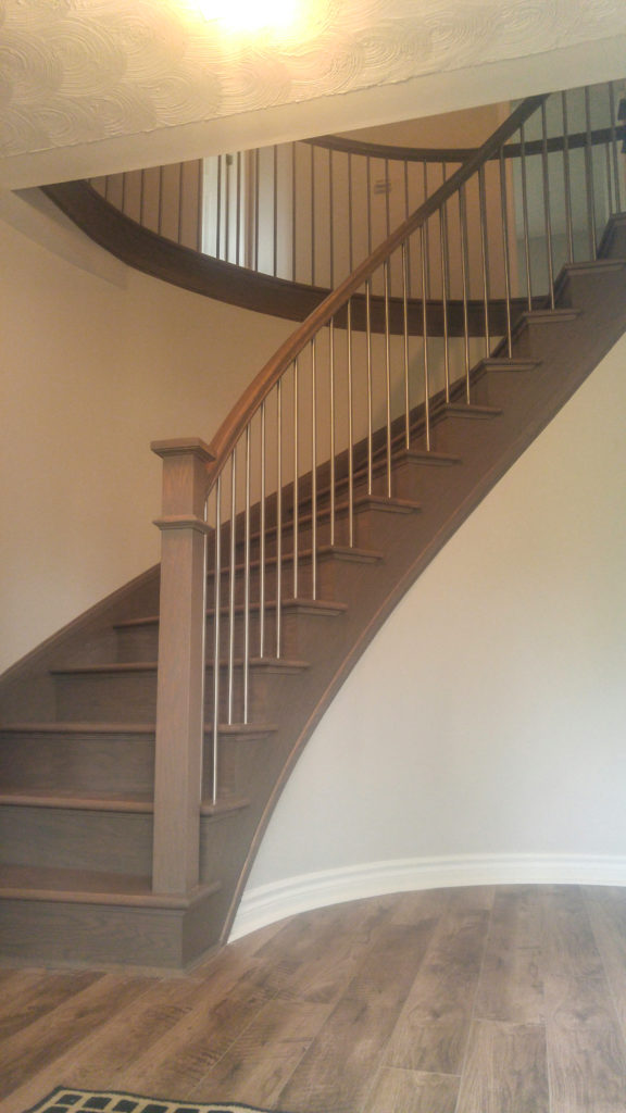 curved staircase with stainless steel balusters